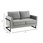 Canapé deux places capitonné en velours avec coussins amovibles et structure en acier inoxydable